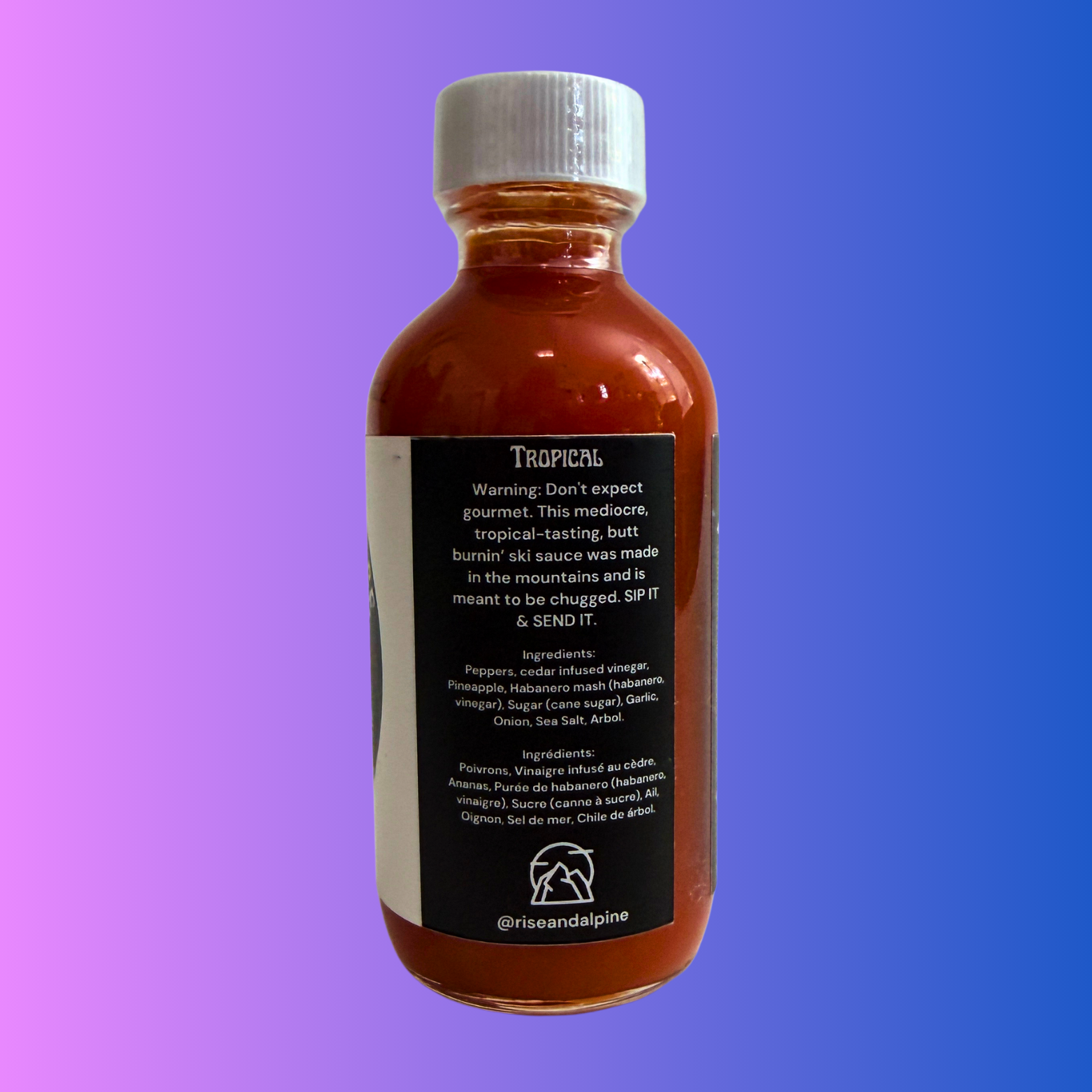 Rise & Alpine Hot Sauce, Ski Fast Burn Ass Tropical Ski Sauce. Side View of bottle. Tropical Flavour. 